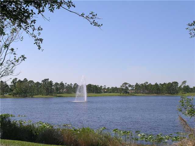 2927 Southeast Racoon Way Stuart, FL 34997 - Photo 21 of 22 a view of a lake with houses in the back