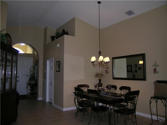2927 Southeast Racoon Way Stuart, FL 34997 - Photo 4 of 22 a view of a dining room with furniture and chandelier