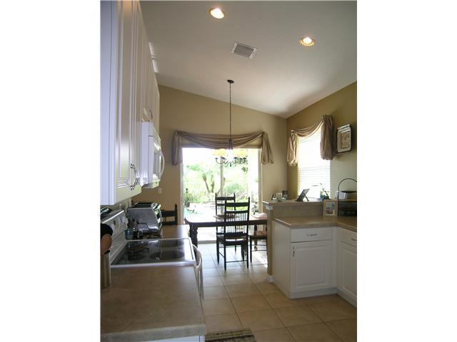 2927 Southeast Racoon Way Stuart, FL 34997 - Photo 7 of 22 a dining room with furniture and a large window