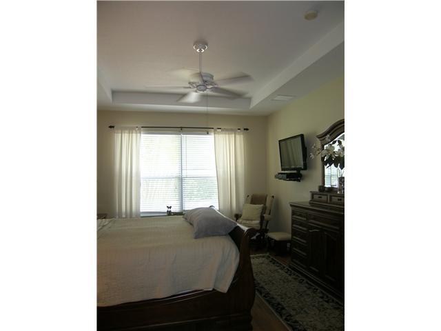 2927 Southeast Racoon Way Stuart, FL 34997 - Photo 9 of 22 a bed room with a bed and a television