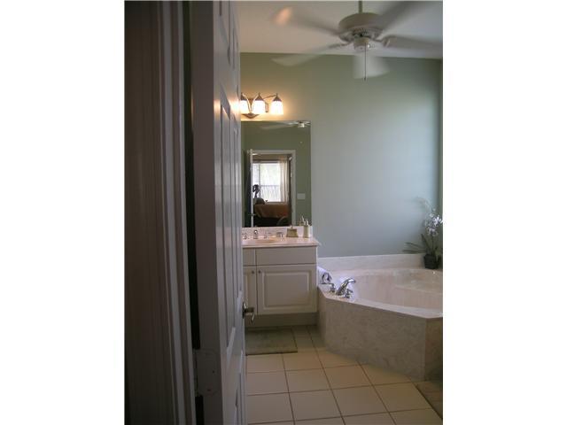 2927 Southeast Racoon Way Stuart, FL 34997 - Photo 10 of 22 a bathroom with a sink and a mirror
