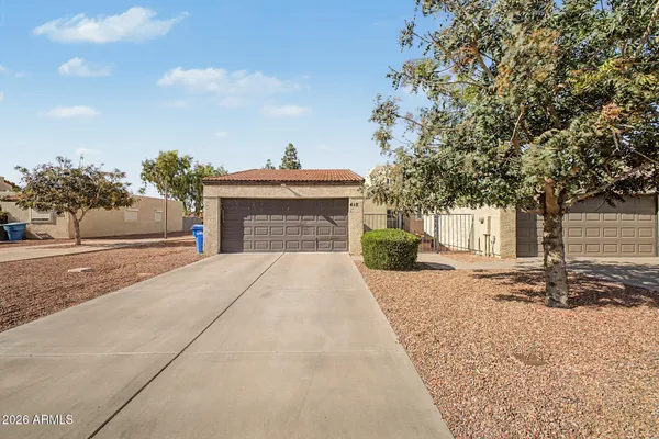 a front view of a house with a yard and a garage