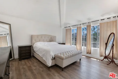 a bedroom with bed and a chandelier