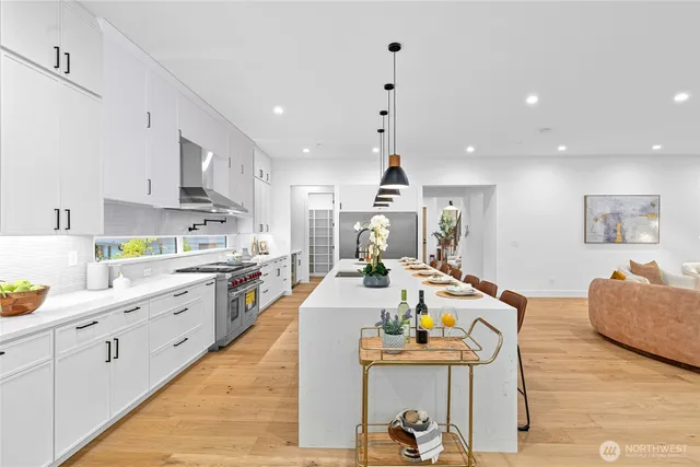 a large kitchen with a table and chairs