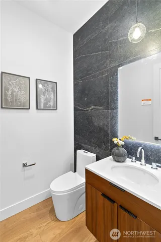 a bathroom with a sink a toilet and mirror