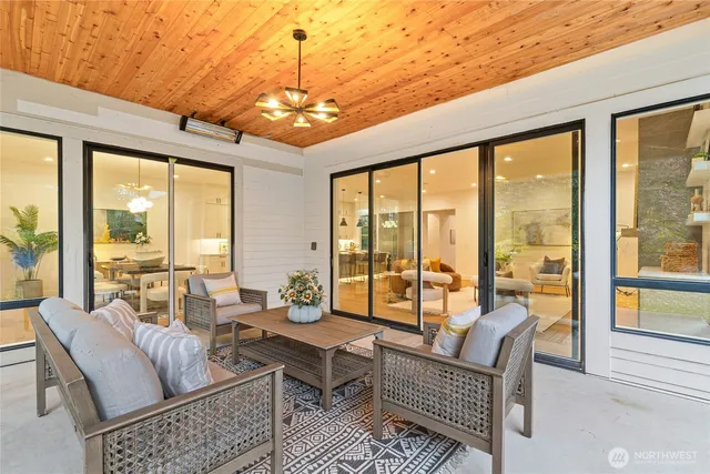 a living room with furniture and a chandelier