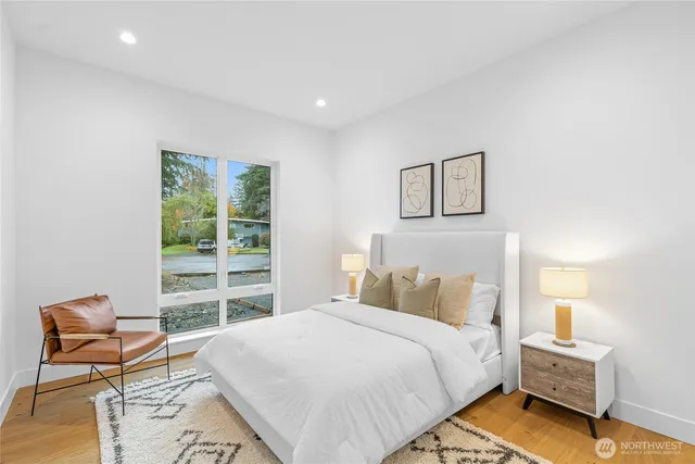 a bedroom with a bed and wooden floor