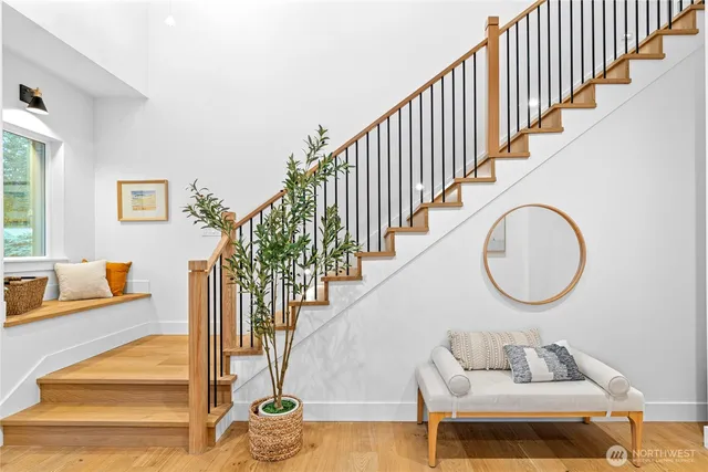 a view of entryway and hall with wooden floor
