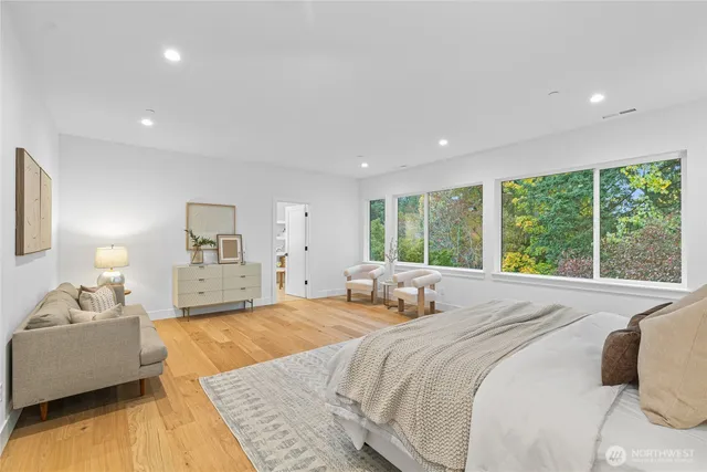 a spacious bedroom with a large bed and a couch