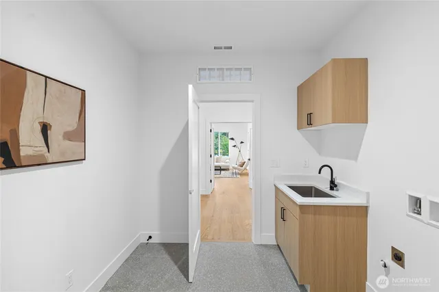 a view of a sink and mirror in a room