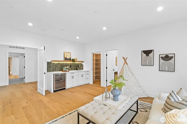 a open kitchen with stainless steel appliances kitchen island granite countertop a refrigerator a stove a sink dishwasher with a dining table and chairs