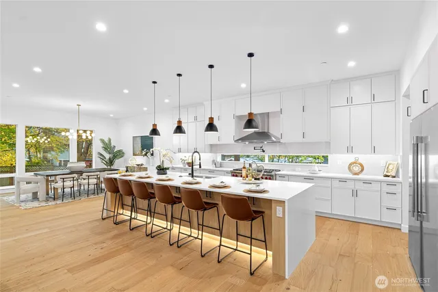 a kitchen with stainless steel appliances kitchen island granite countertop a sink and cabinets