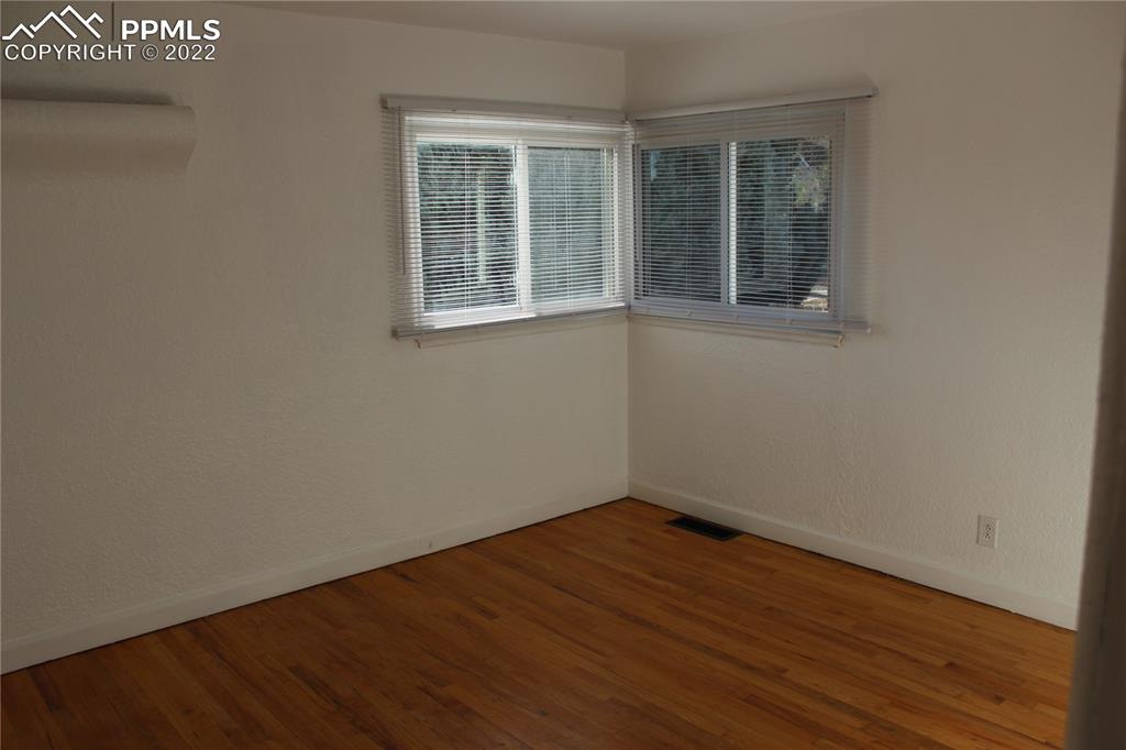 2906 High Street Pueblo, CO 81008 - Photo 11 of 25 a view of empty room with wooden floor and fan