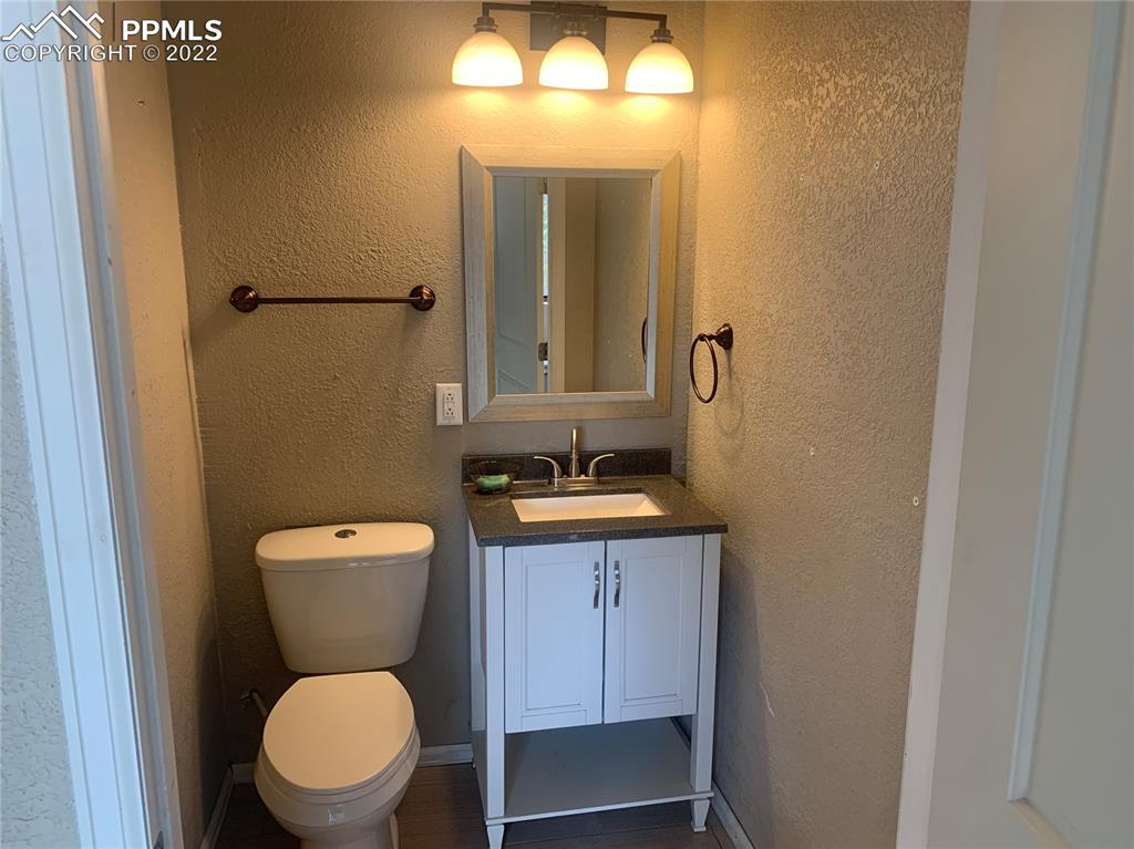 2906 High Street Pueblo, CO 81008 - Photo 14 of 25 a bathroom with a toilet a sink and mirror