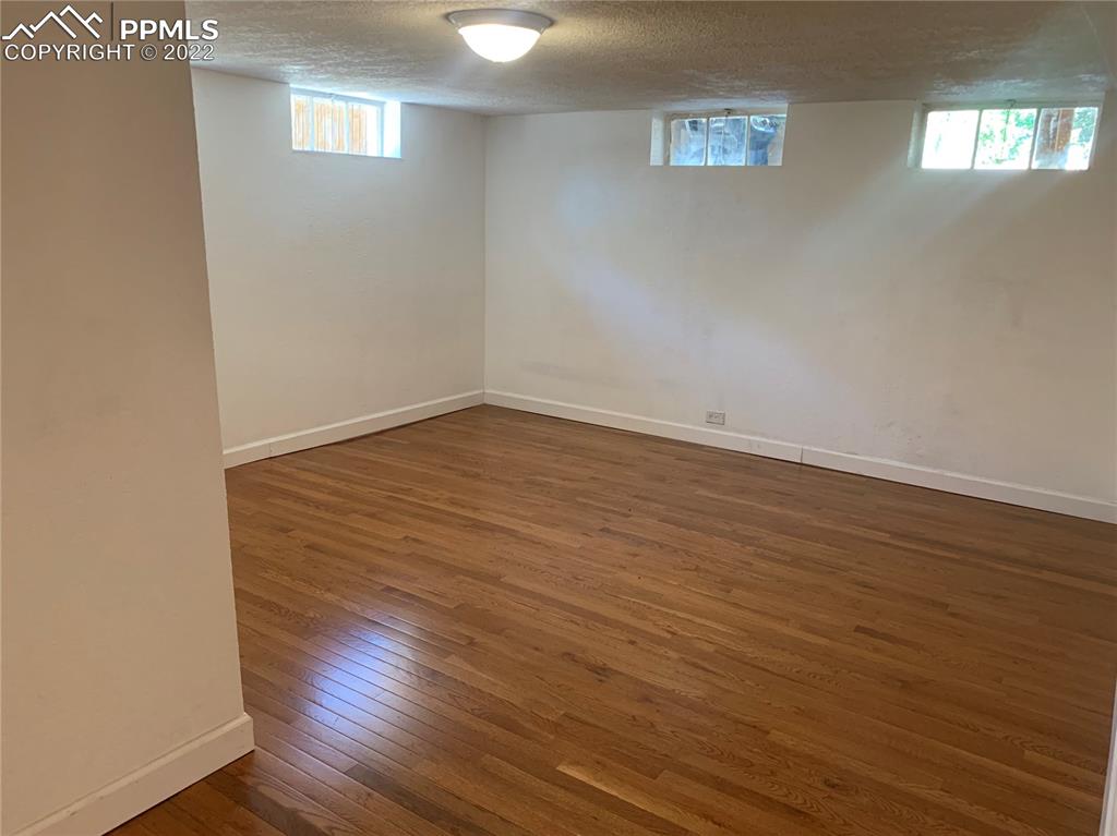 2906 High Street Pueblo, CO 81008 - Photo 16 of 25 a view of an empty room with wooden floor and a window