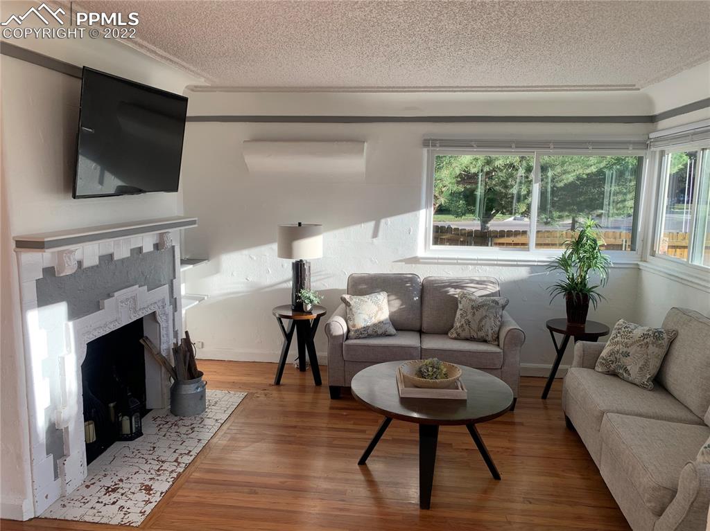 2906 High Street Pueblo, CO 81008 - Photo 4 of 25 a living room with furniture a flat screen tv and a fireplace