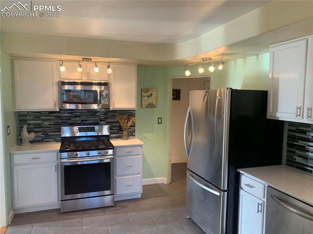 2906 High Street Pueblo, CO 81008 - Photo 7 of 25 a kitchen with a refrigerator stove and microwave