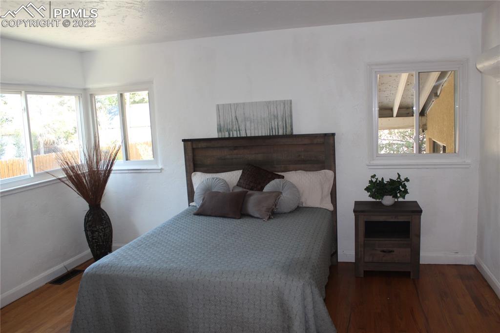 2906 High Street Pueblo, CO 81008 - Photo 9 of 25 a bedroom with a bed and wooden floor