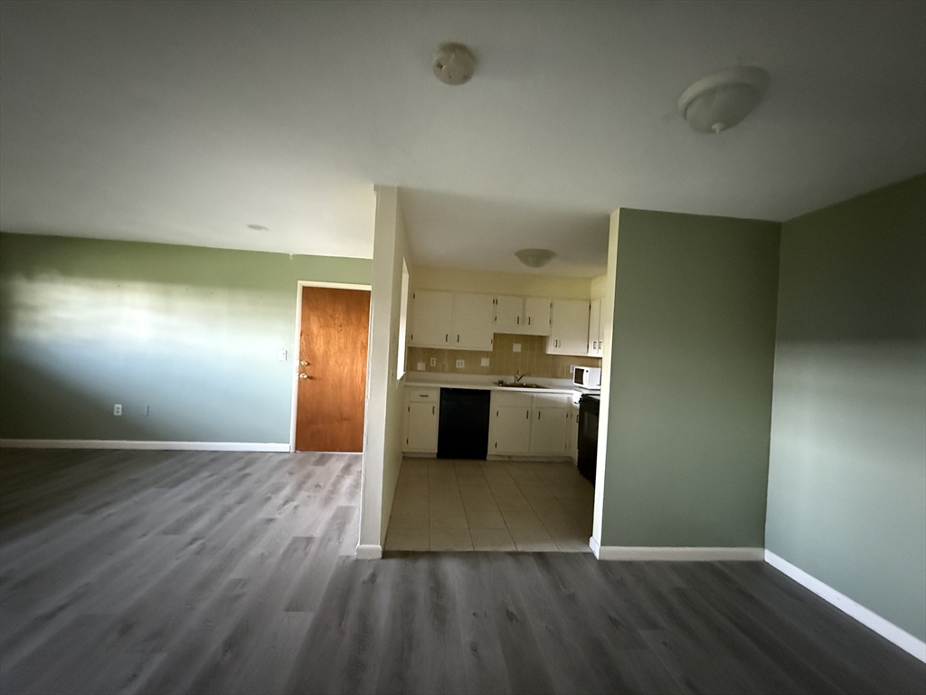 12 Williamsburg Court, Unit 2 Shrewsbury, MA 01545 - Photo 13 of 36 a view of a kitchen with a sink and a refrigerator