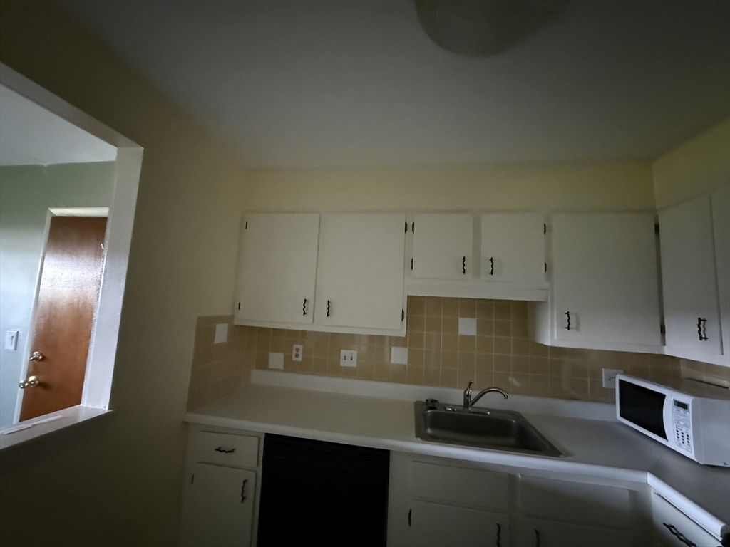 12 Williamsburg Court, Unit 2 Shrewsbury, MA 01545 - Photo 18 of 36 a kitchen with a sink and cabinets