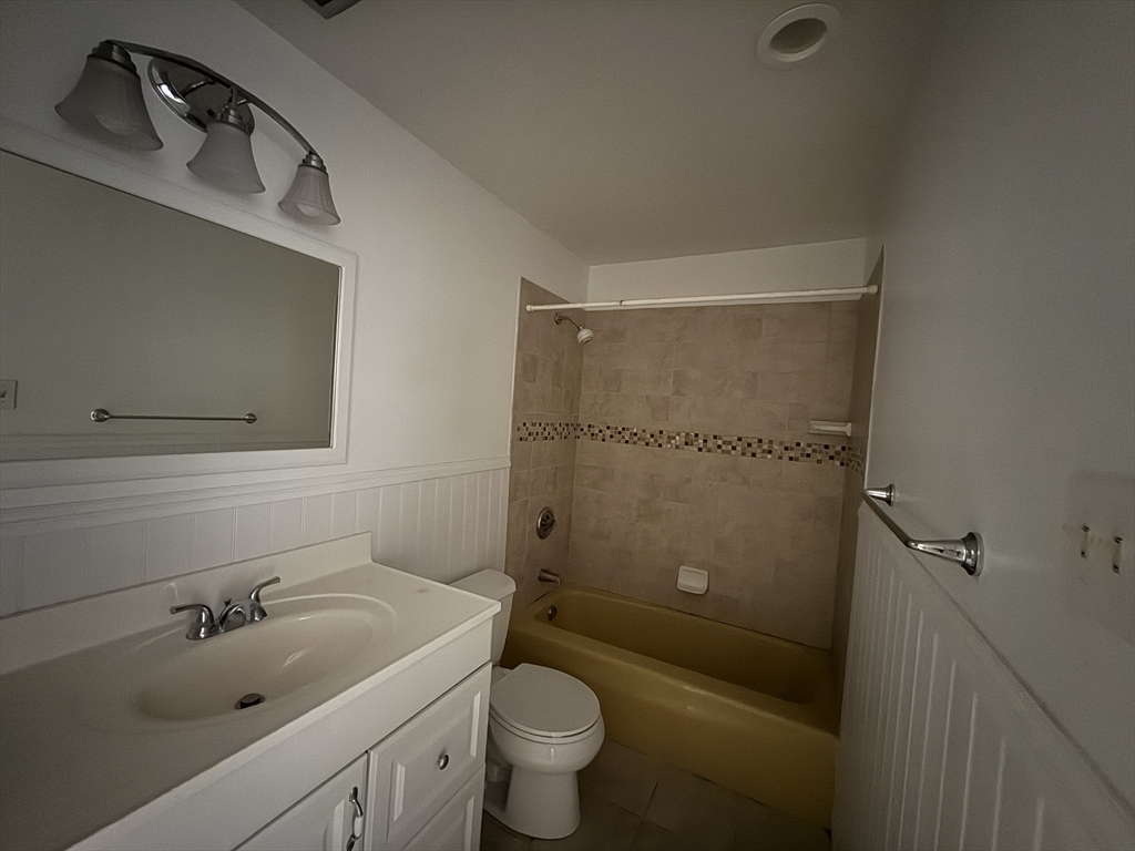 12 Williamsburg Court, Unit 2 Shrewsbury, MA 01545 - Photo 24 of 36 a bathroom with a sink a toilet and shower