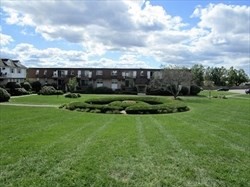 12 Williamsburg Court, Unit 2 Shrewsbury, MA 01545 - Photo 3 of 36 a view of a garden with a building in the background
