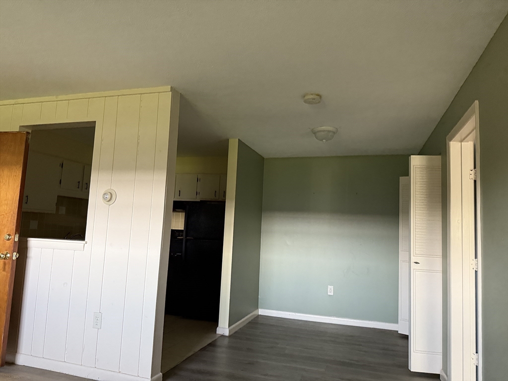 12 Williamsburg Court, Unit 2 Shrewsbury, MA 01545 - Photo 33 of 36 a view of an empty room with wooden floor and closet