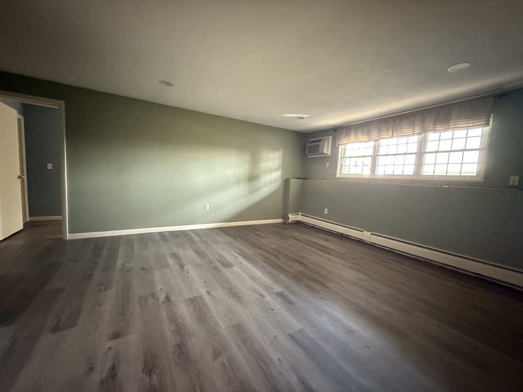 12 Williamsburg Court, Unit 2 Shrewsbury, MA 01545 - Photo 5 of 36 an empty room with wooden floor and windows