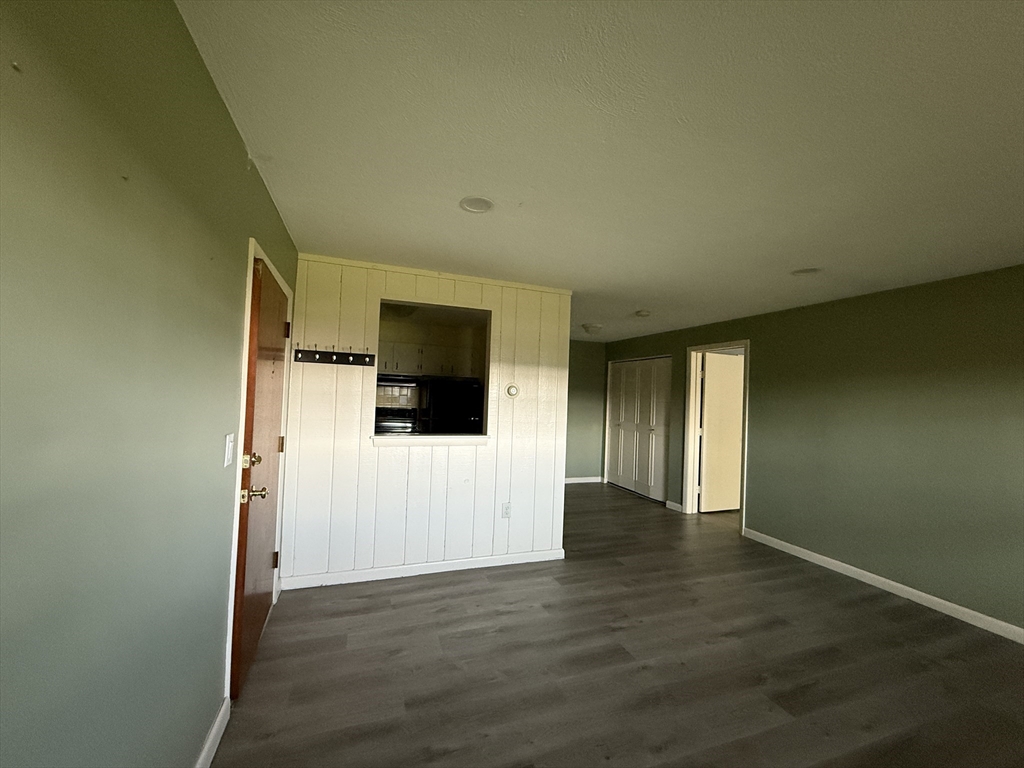 12 Williamsburg Court, Unit 2 Shrewsbury, MA 01545 - Photo 6 of 36 a view of an empty room with wooden floor and a window