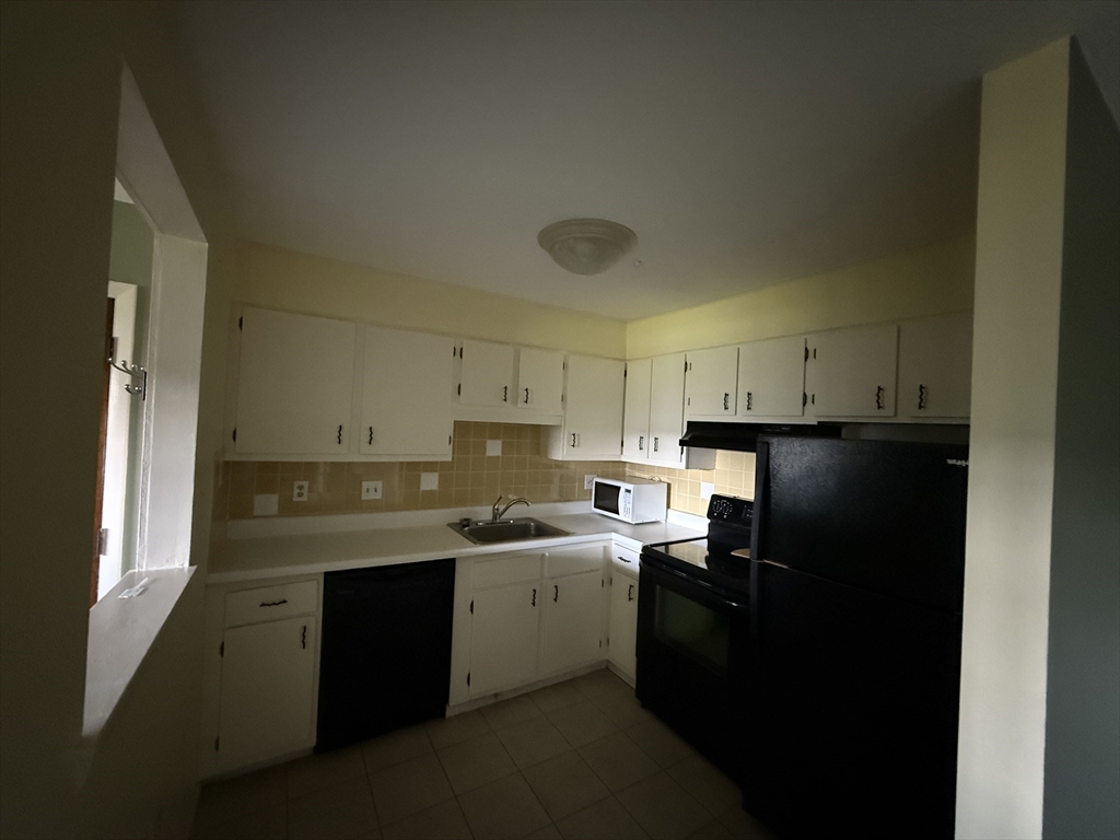 12 Williamsburg Court, Unit 2 Shrewsbury, MA 01545 - Photo 9 of 36 a kitchen with a sink appliances and cabinets