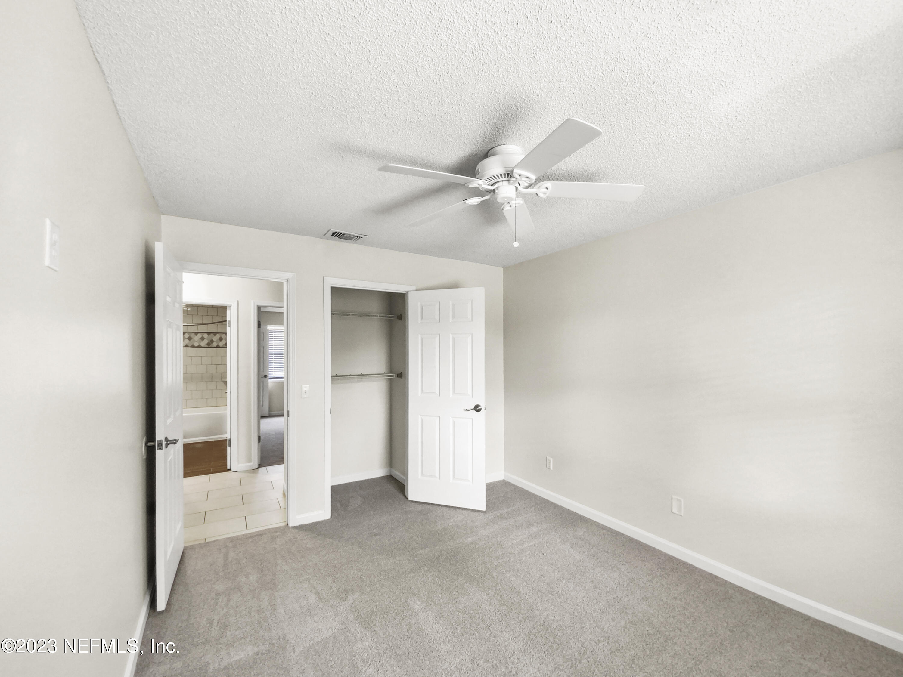 3550 Loretto Road Jacksonville, FL 32223 - Photo 12 of 19 an empty room with a ceiling fan and carpet