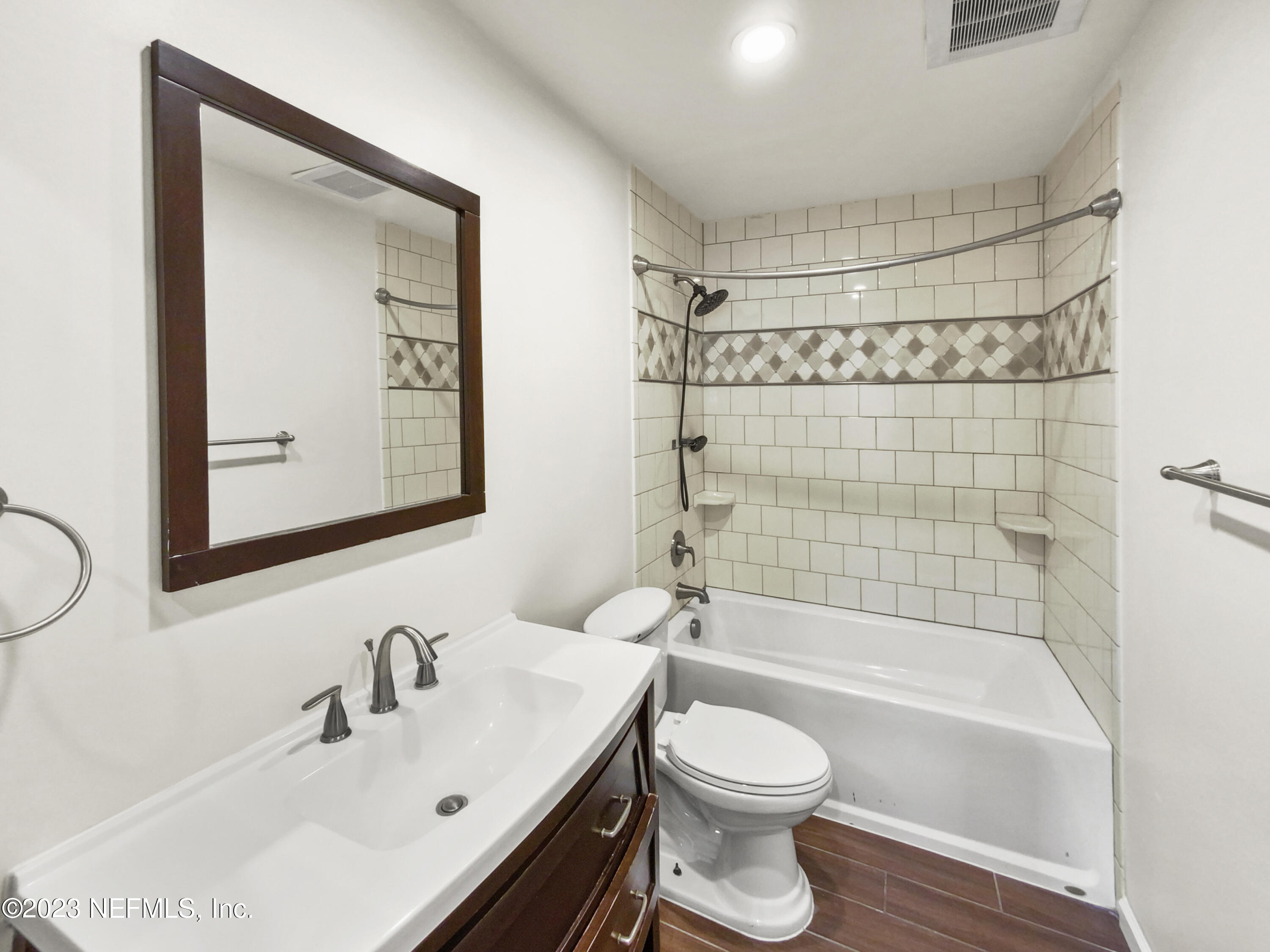 3550 Loretto Road Jacksonville, FL 32223 - Photo 13 of 19 a bathroom with a bathtub shower sink vanity and toilet