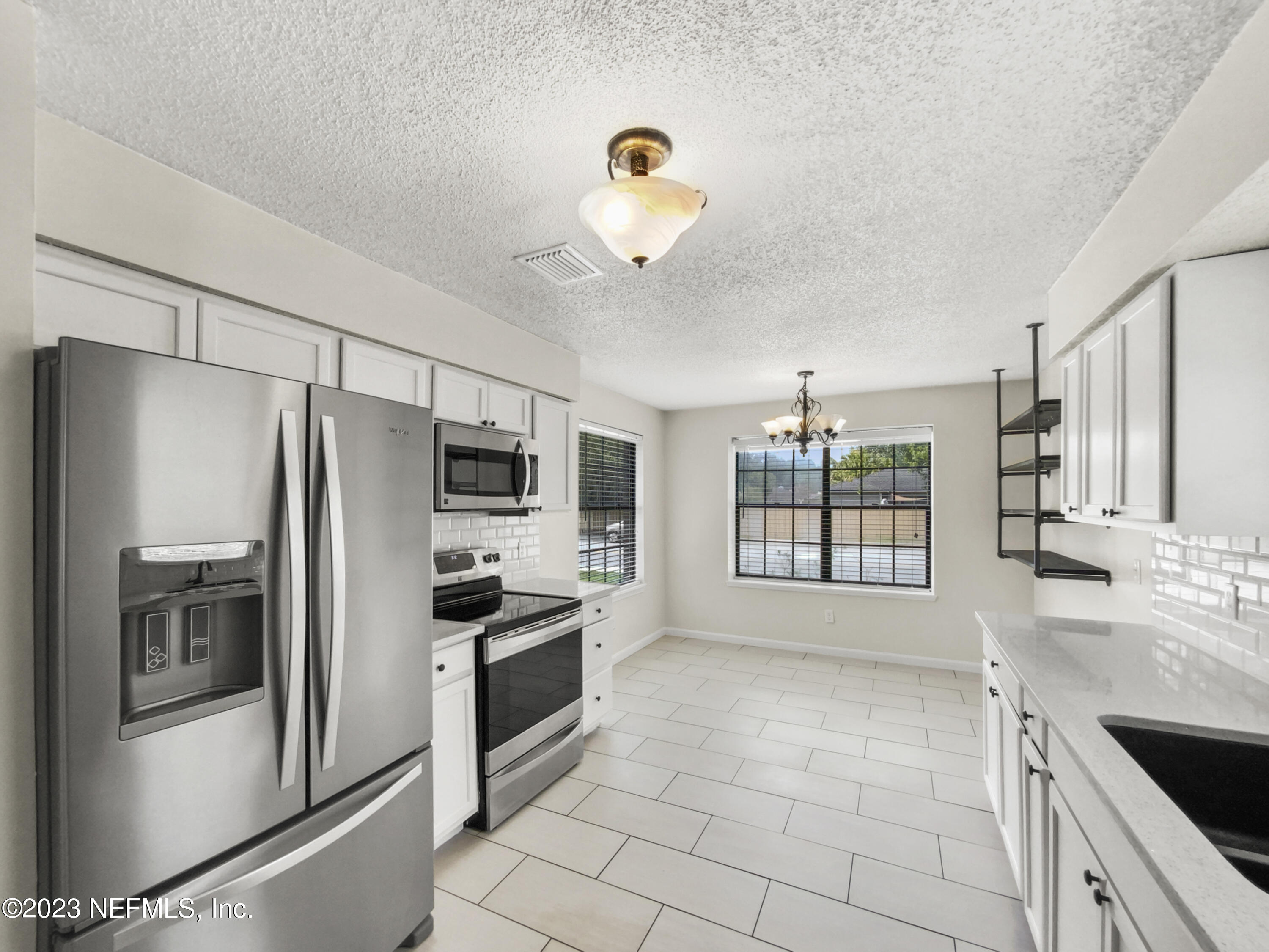 3550 Loretto Road Jacksonville, FL 32223 - Photo 4 of 19 a kitchen with granite countertop a refrigerator and a sink