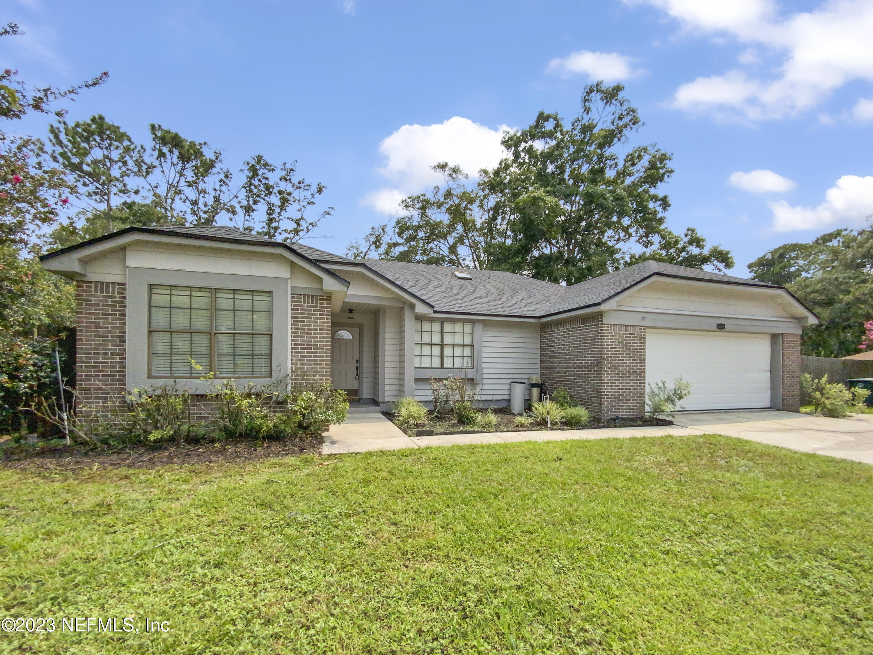 3550 Loretto Road Jacksonville, FL 32223 - Photo 5 of 19 a front view of a house with a yard and garage