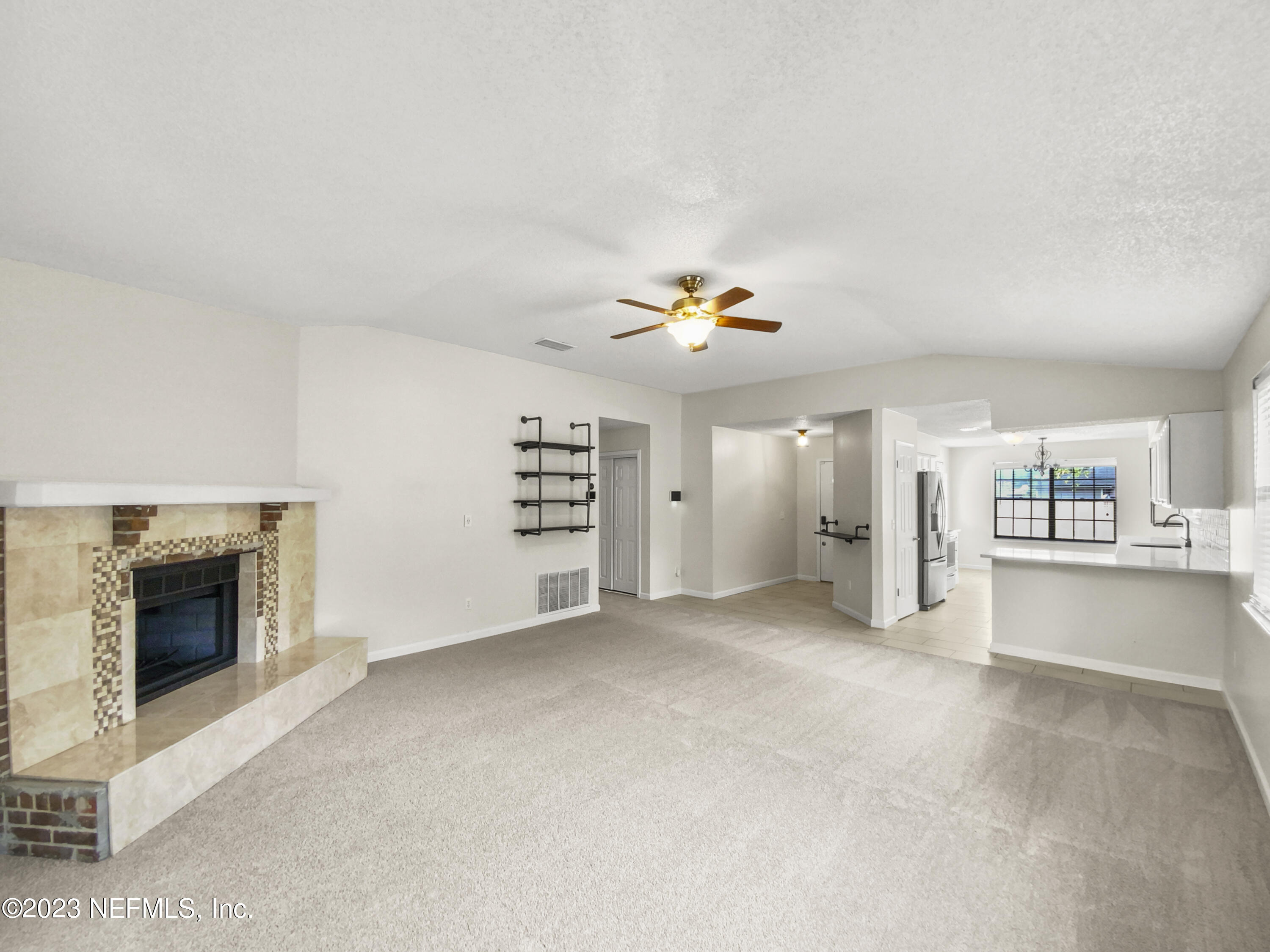 3550 Loretto Road Jacksonville, FL 32223 - Photo 7 of 19 an empty room with windows and fireplace