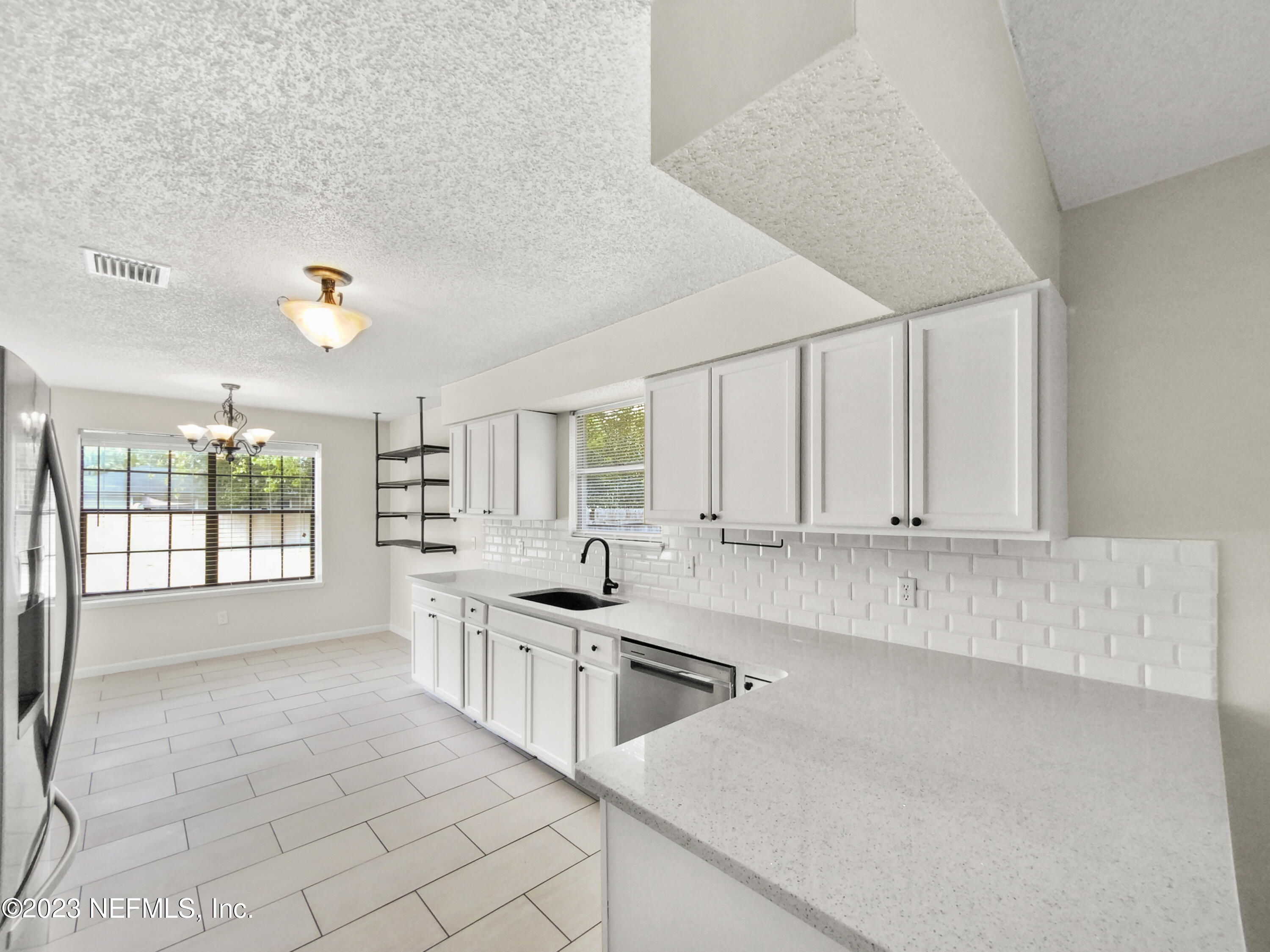 3550 Loretto Road Jacksonville, FL 32223 - Photo 8 of 19 a kitchen with stainless steel appliances a sink stove and cabinets