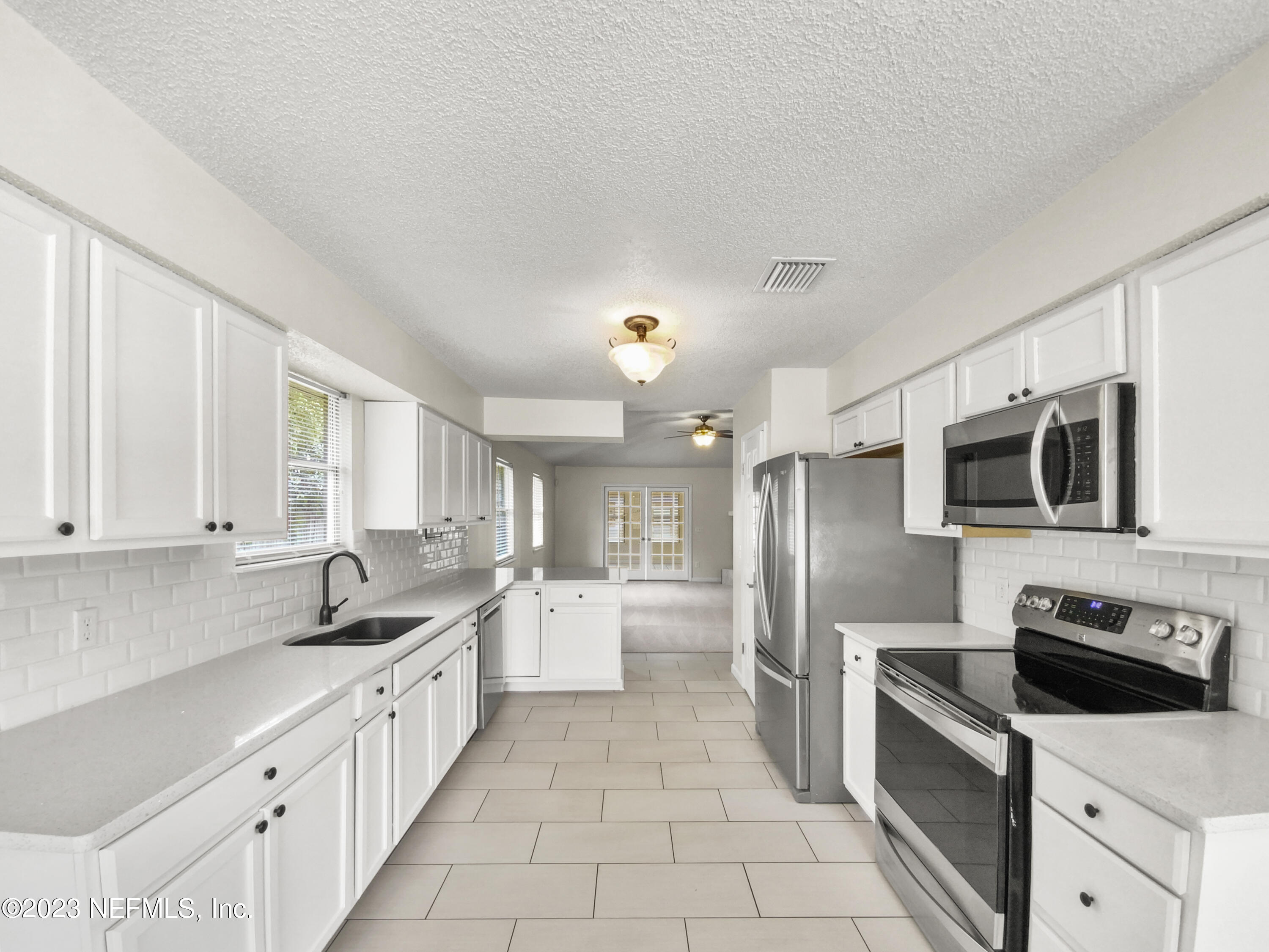 3550 Loretto Road Jacksonville, FL 32223 - Photo 10 of 19 a kitchen with stainless steel appliances a refrigerator sink and stove