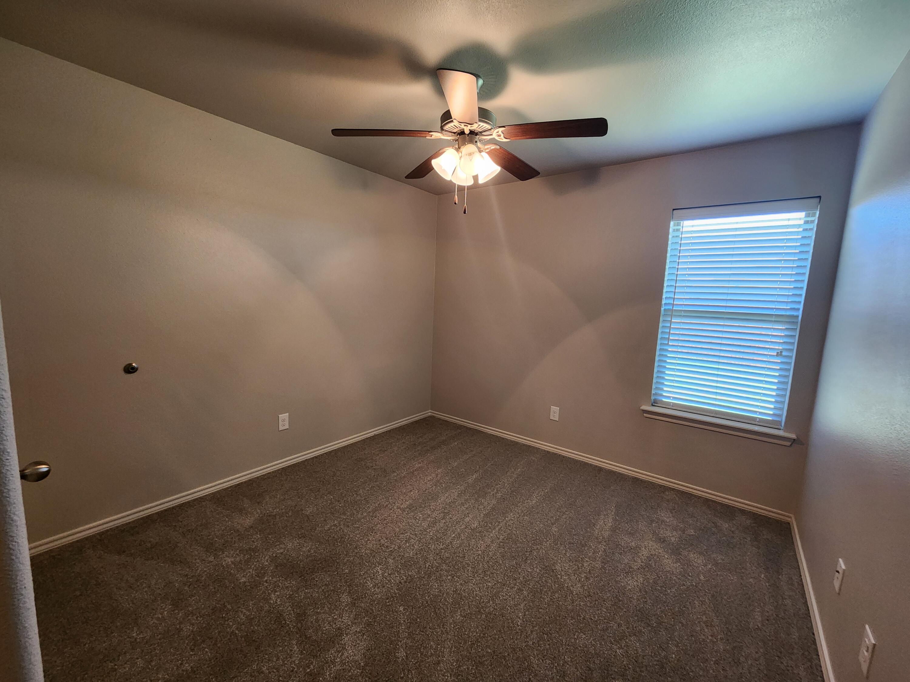 8702 13th Street Lubbock, TX 79416 - Photo 13 of 25 a view of an empty room with a window