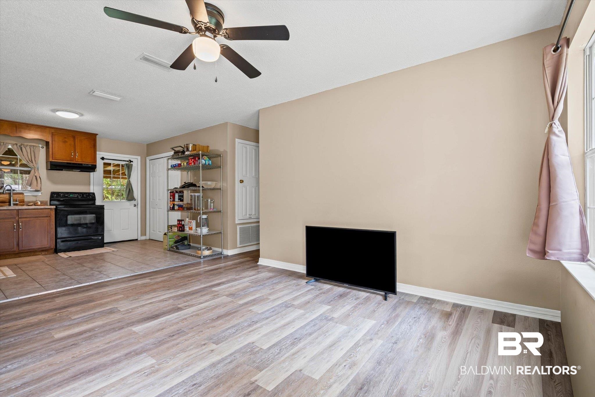 14165 River Oaks Road, Unit A & B Coden, AL 36523 - Photo 2 of 35 Living room with light wood-style floors, a ceiling fan, and a textured ceiling