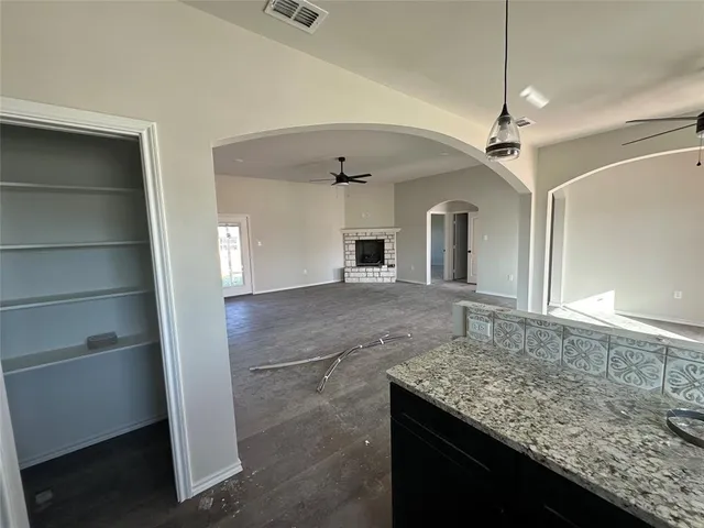a bathroom with a granite countertop sink a toilet and shower