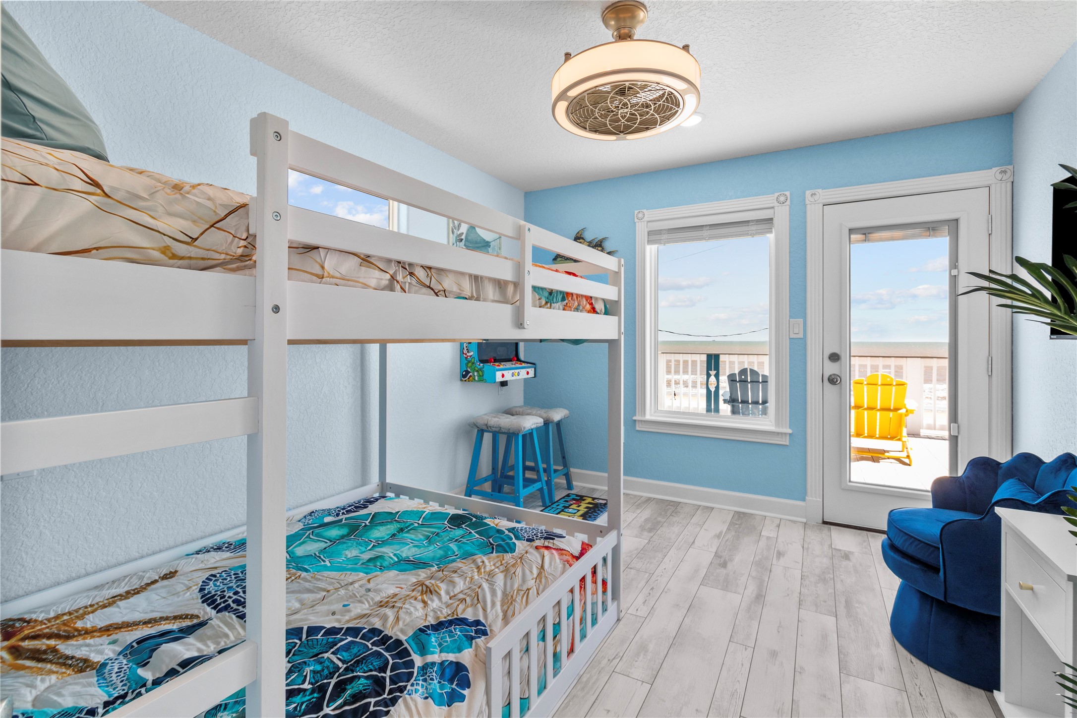 622 Fin Alley Surfside Beach, TX 77541 - Photo 11 of 33 Bunk beds and a wall mounted arcade video game. Direct access to balcony from the bedroom.