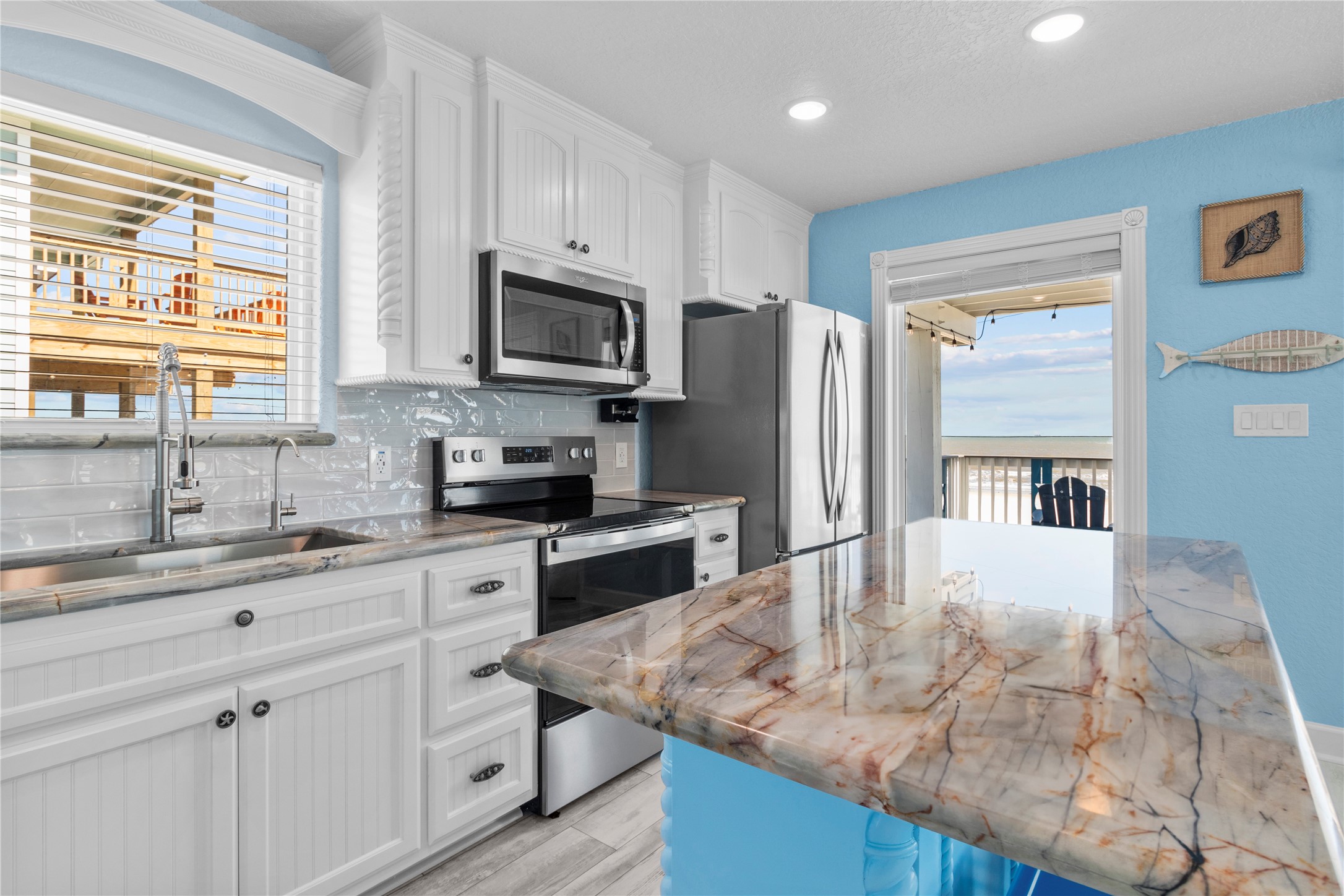 622 Fin Alley Surfside Beach, TX 77541 - Photo 7 of 33 LUXURY Brazilian Quartzite countertop with beautiful veining throughout the kitchen.
