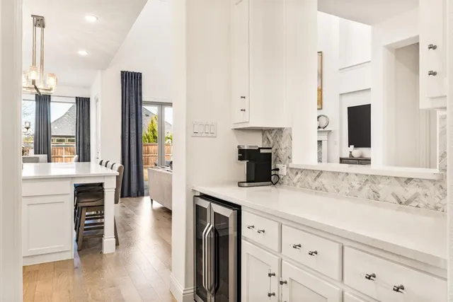 a kitchen with kitchen island granite countertop a sink a stove and cabinets