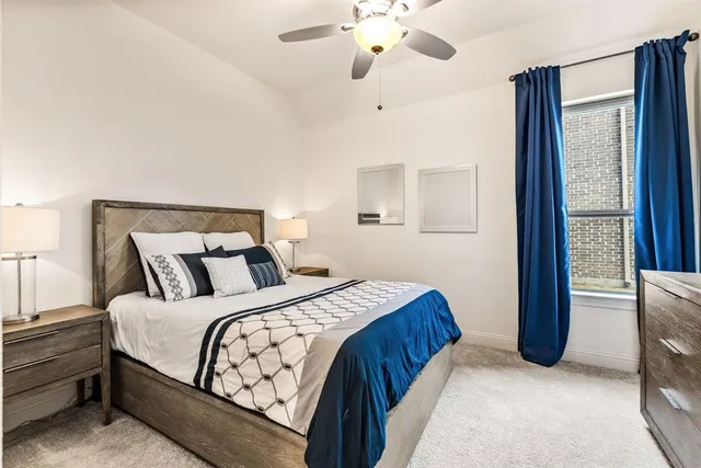 a bedroom with a large bed and a chandelier