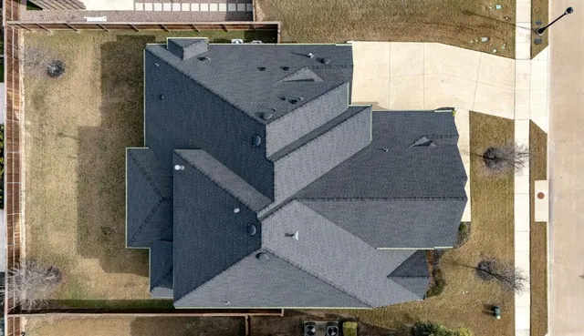 an aerial view of residential houses with outdoor space