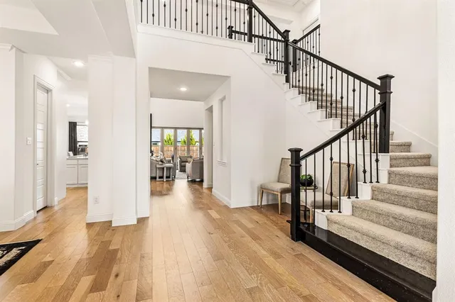 a view of entryway and hall with wooden floor