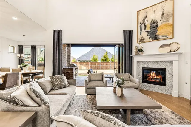 a living room with furniture fireplace and a large window