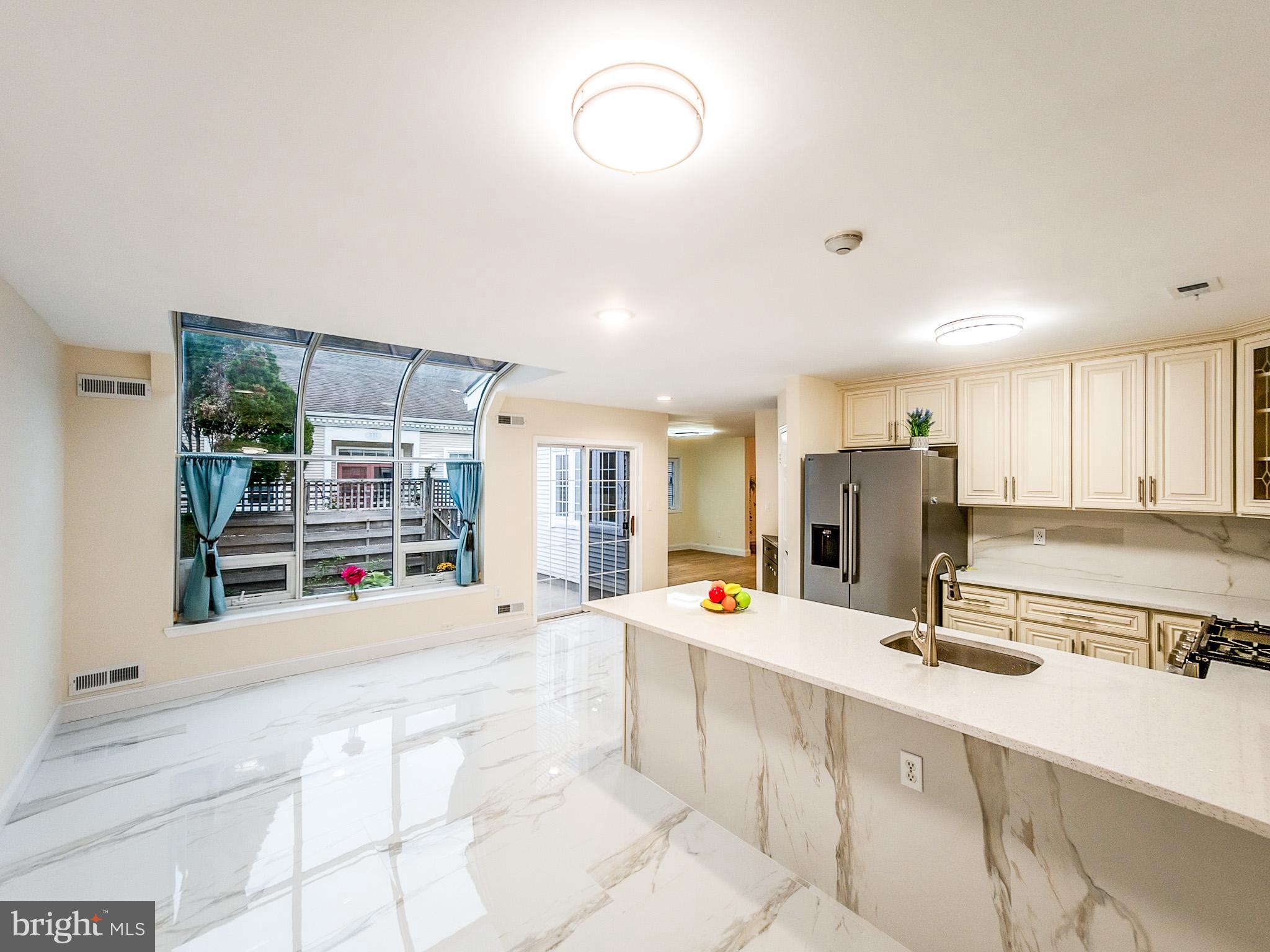 7 C Rutland Lane Monroe Township, NJ 08831 - Photo 26 of 41 a view of a kitchen with stainless steel appliances granite countertop a sink and cabinets