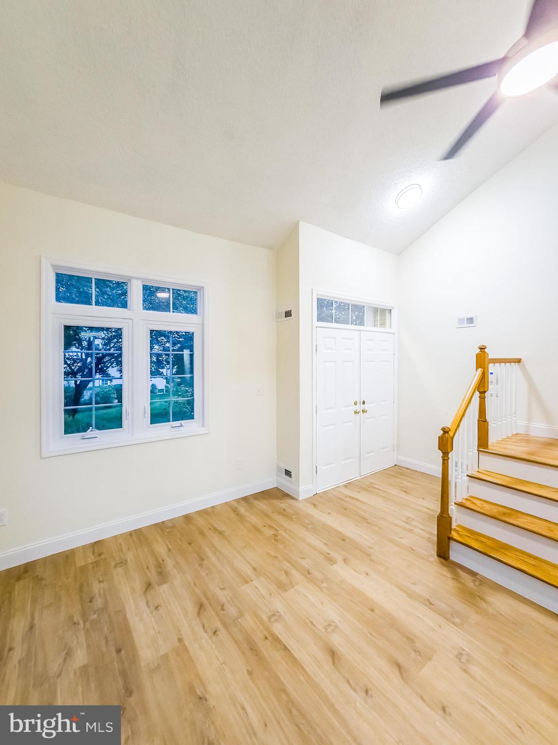 7 C Rutland Lane Monroe Township, NJ 08831 - Photo 7 of 41 a view of an empty room with wooden floor and a window