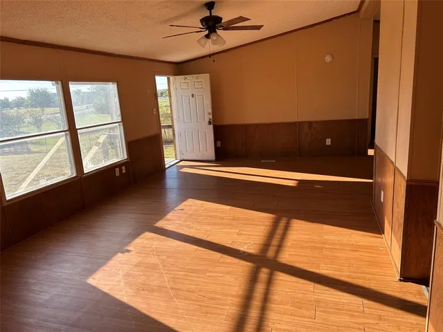 a view of room with window and wooden floor